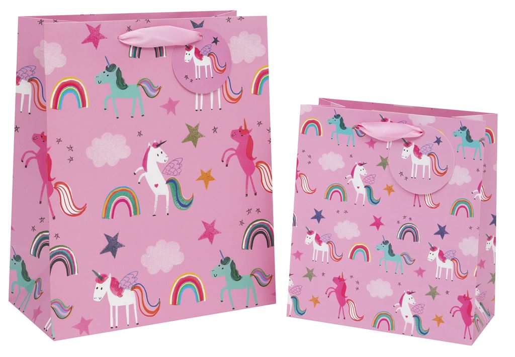 Two pink gift bags - one larger than the other - with varying coloured unicorns in different standing or prancing positions - some are white, some pink or turquoise. Rainbows, clouds and stars also feature. There is a pink ribbon handle and a pink gift tag attached to it with a white winged unicorn image on it.
