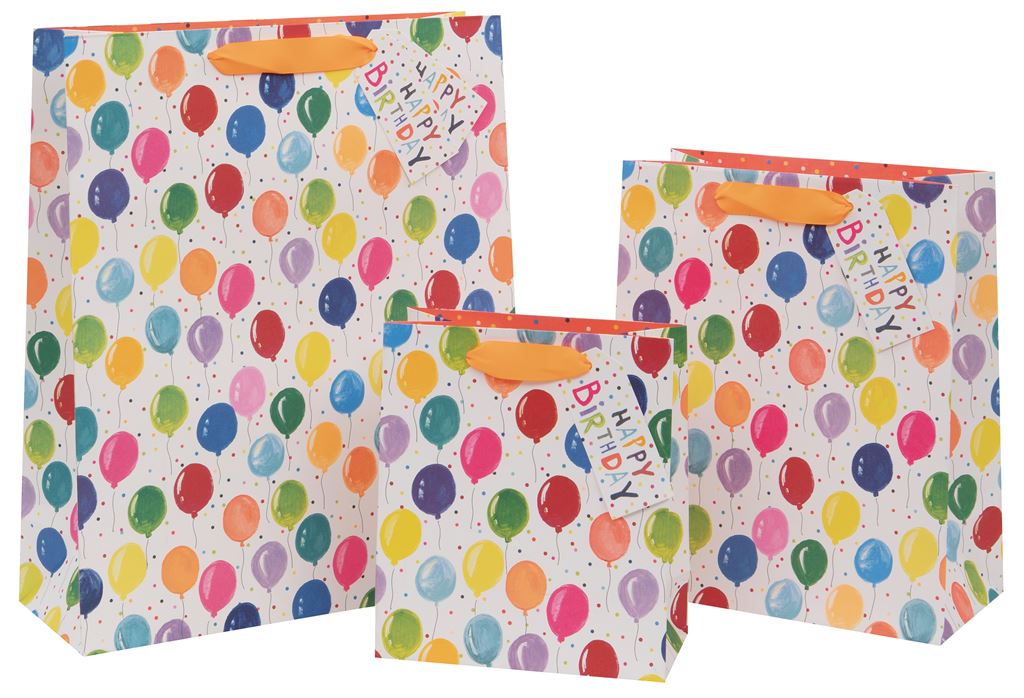 Three gift bags with a white background covered in a rainbow of coloured balloons with strings dangling. The white background also has some multicoloured spots embellishing it. There is an orange ribbon handle with a gift tag attached with the words Happy Birthday in a haphazard type.