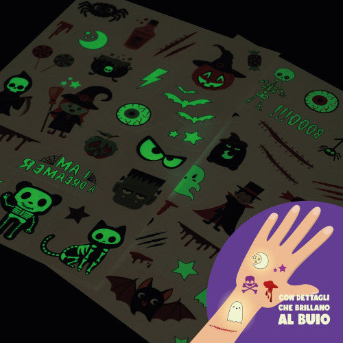 Halloween-themed temporary tattoos with glowing designs on a dark surface, accompanied by a hand with tattoos.