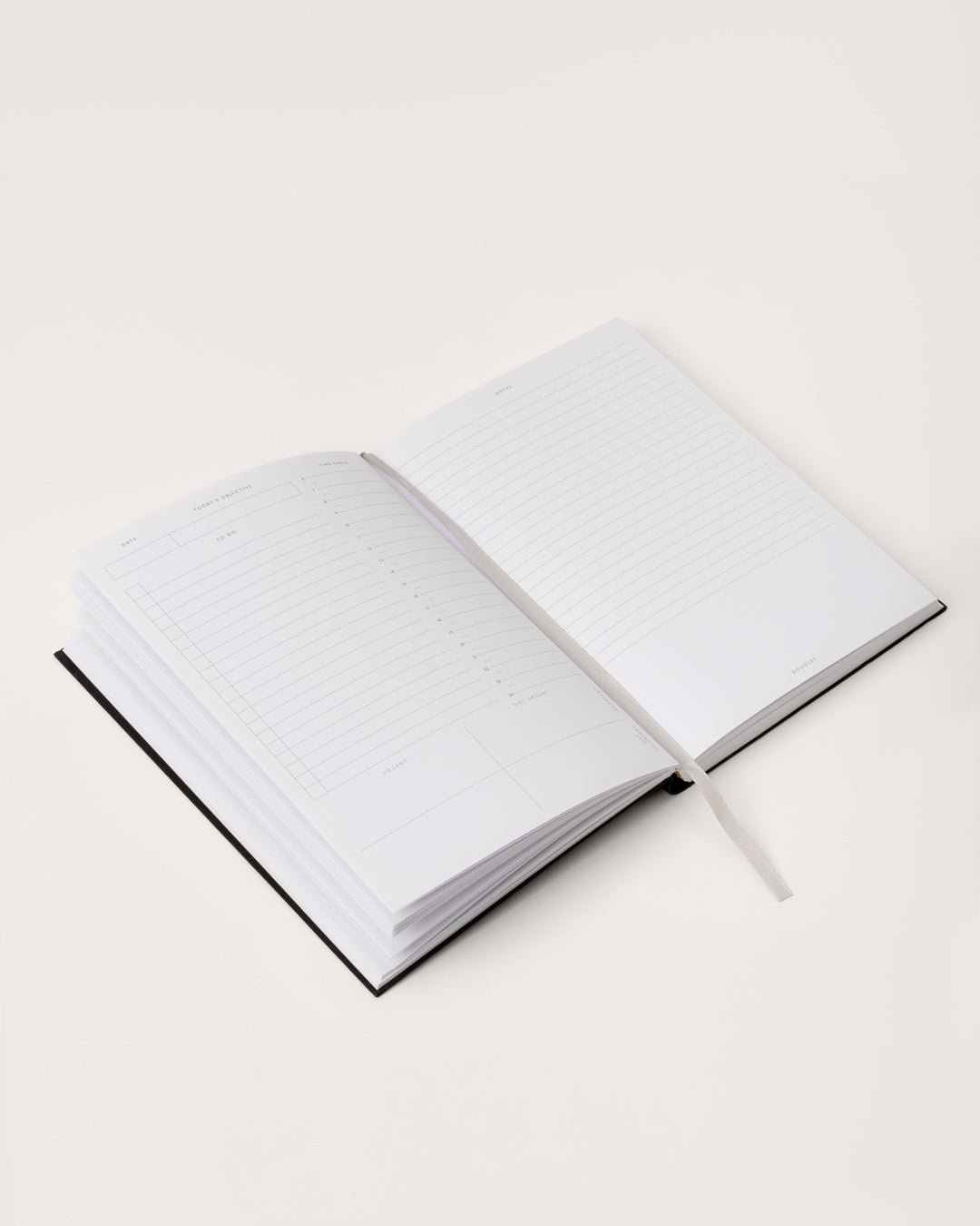 An image of the inside spread of a planner and the ribbon page marker.
