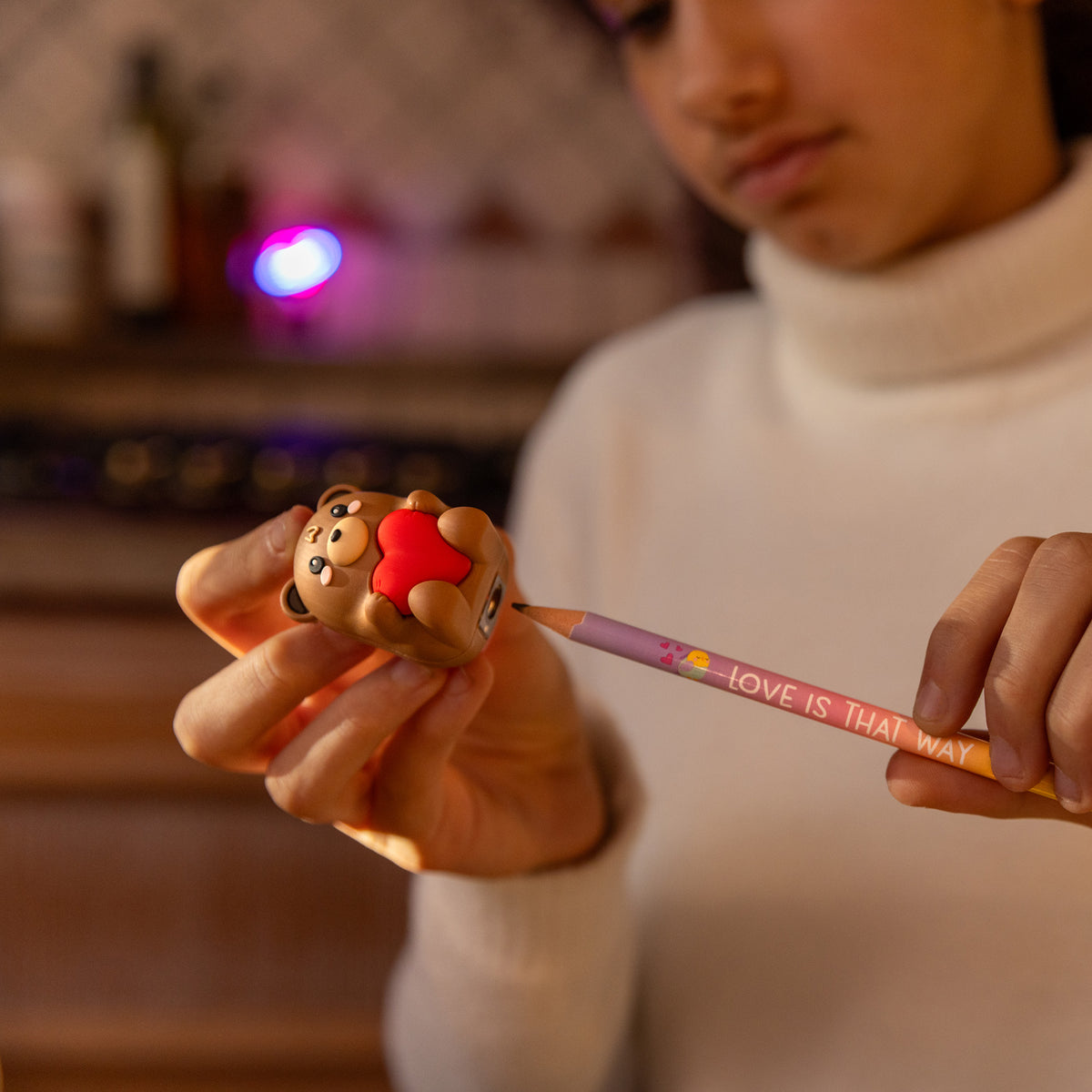 Legami Light Up Teddy Bear Pencil Sharpener by penny black showing a child using it to sharpen a pencil