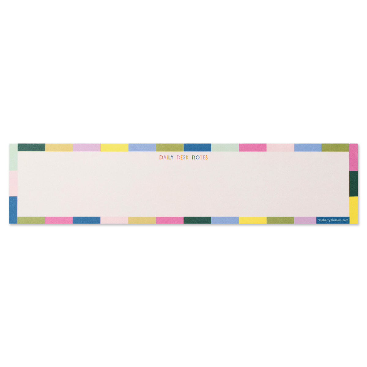 An oblong notepad that is a light cream in colour with a colourblocked outline around the outside of the pad. It says in small multicoloured block capitals &#39;Daily Desk Notes&#39;.