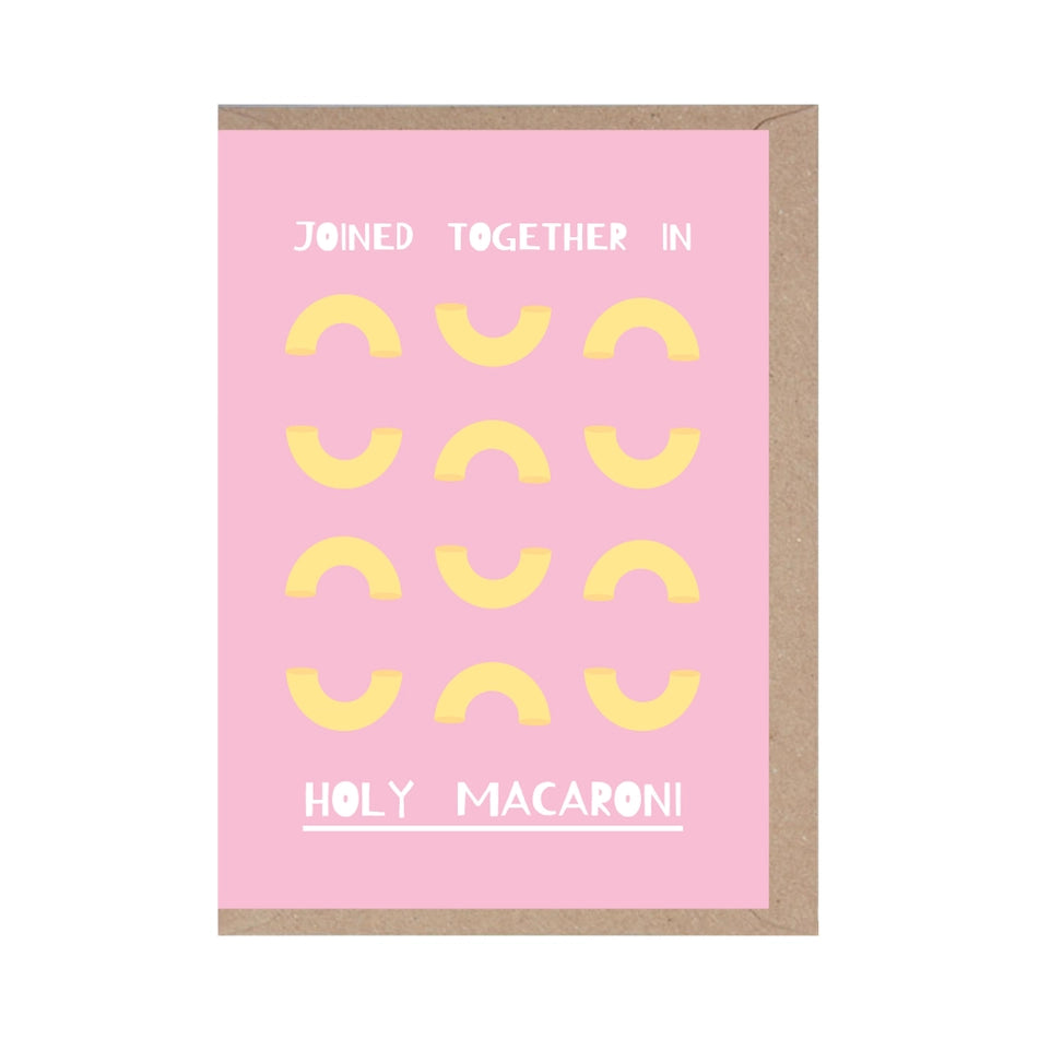 A pink coloured greetings card for a wedding, covered in illustrations of macaroni and the words 'joined together in holy macaroni'.