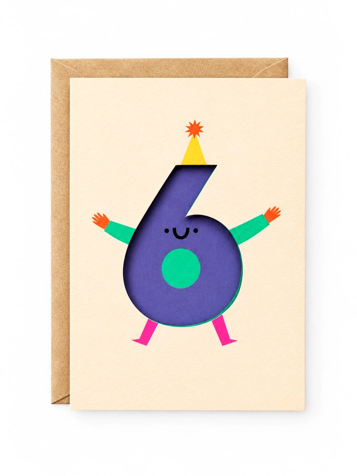 A cream 6th birthday card featuring a colourful number 6 character with arms and legs, shown with a brown kraft envelope behind it on a white background.