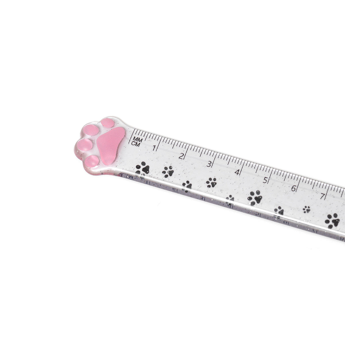 Image of a clear glittery ruler with small black cat pawprints along it with one large cat paw print at the top with pink pads.