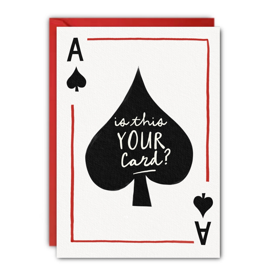 A funny greeting card designed like an Ace of Spades playing card, with the text 'is this YOUR Card?' in white script over a large black spade. The card is shown with a red envelope behind it on a plain white background. at penny black