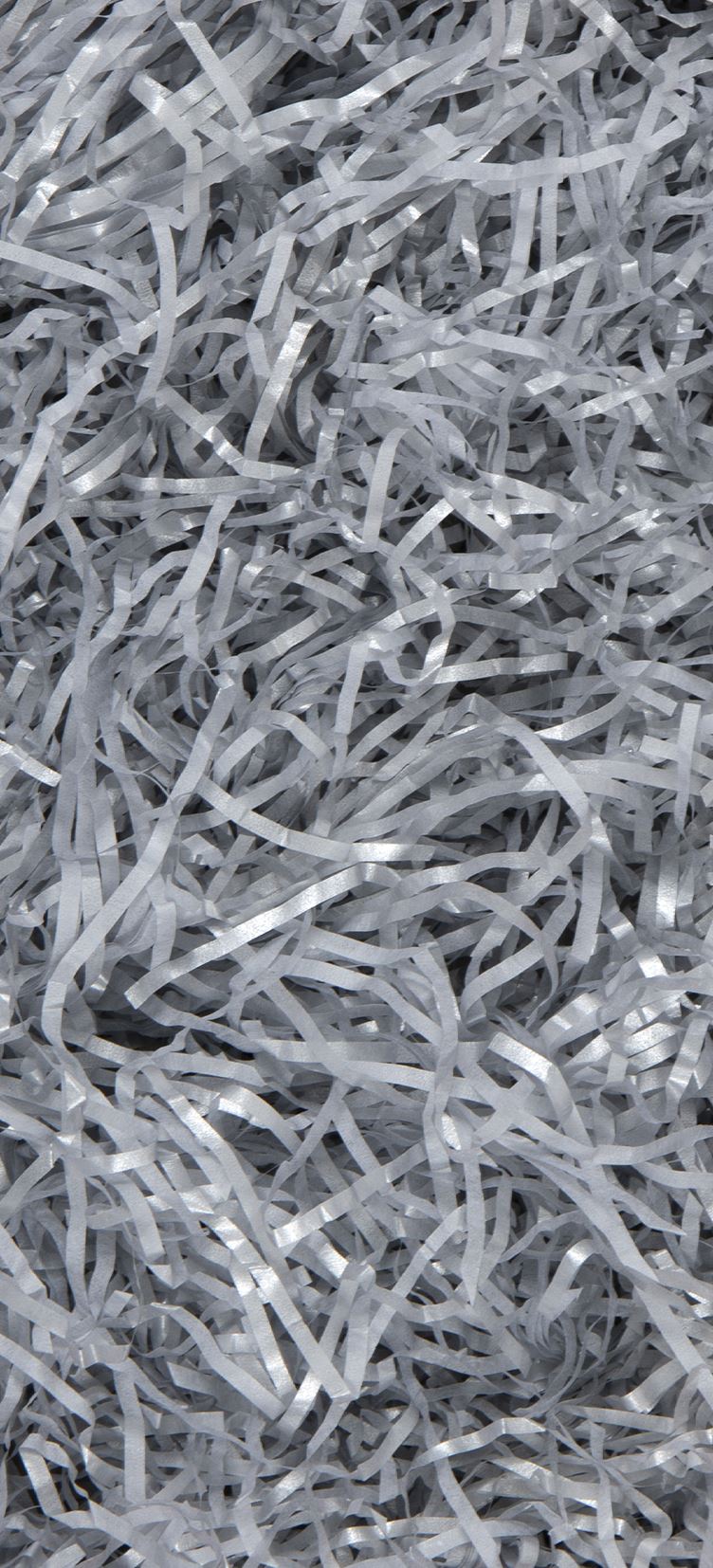 A close-up view of metallic silver paper shred strips filling the frame.
