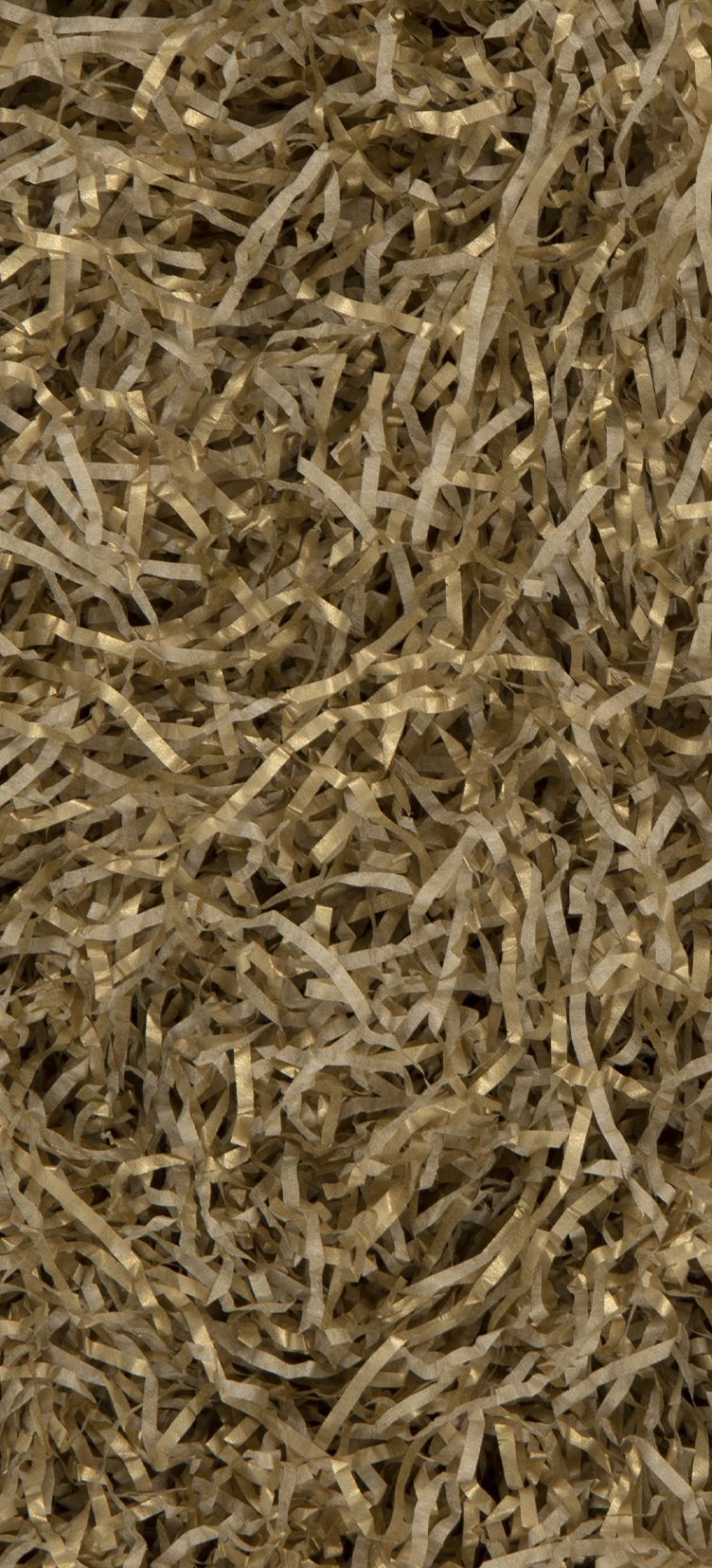 A close-up texture shot of shredded gold paper filling the entire frame.