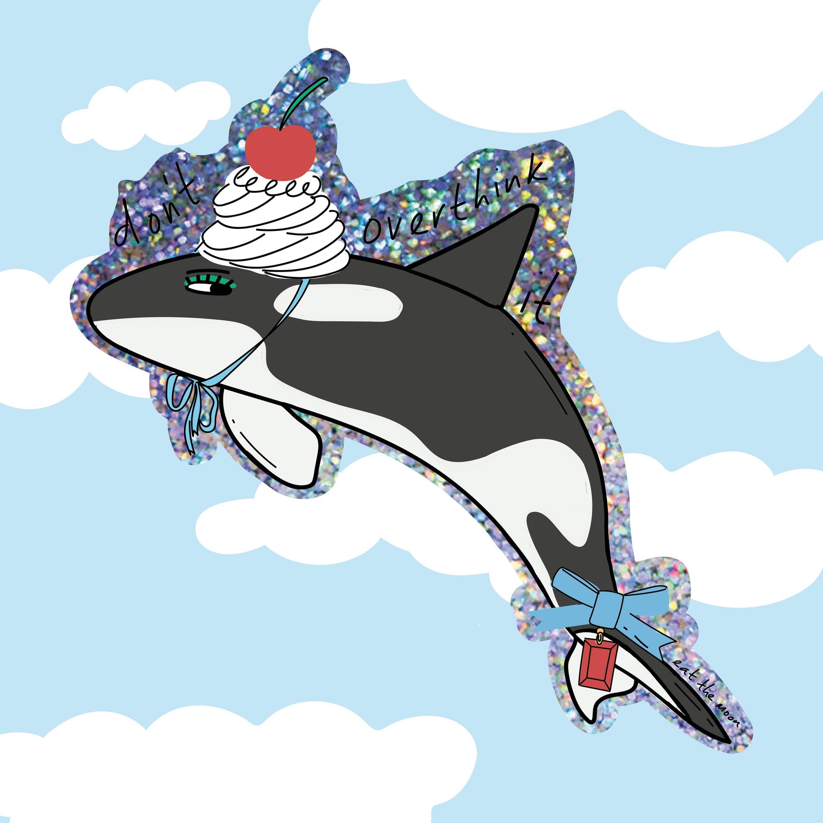 An Orca whale glitter sticker with a dollop of cream and cherry on top against a blue sky with clouds and a bow trinket attached to it's tail. 