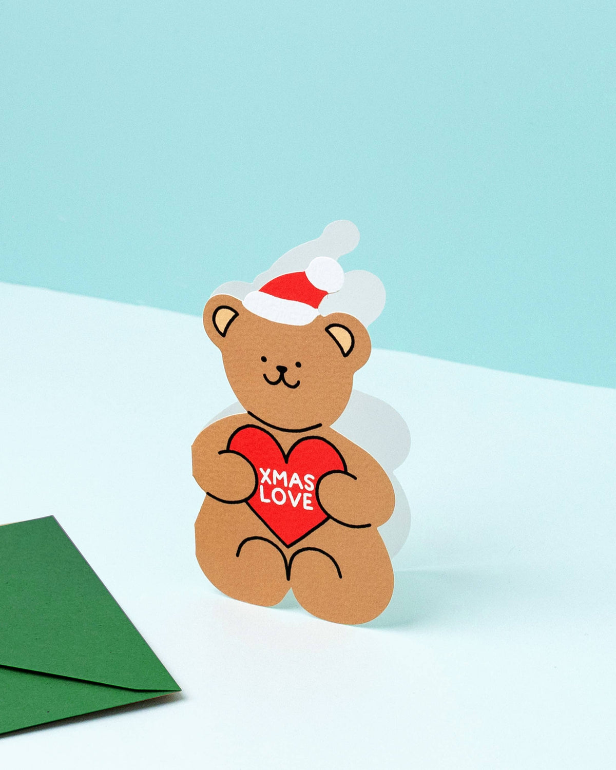 Xmas Love Cut-Out Teddy Bear Christmas Card on a tabletop by penny black
