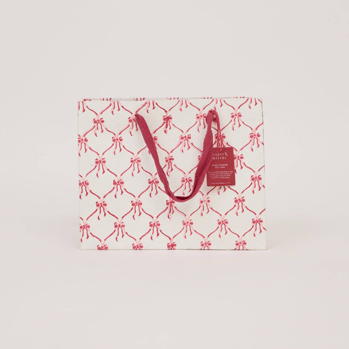 Pink christmas bow design block printed gift bag by paper mirchi and penny black