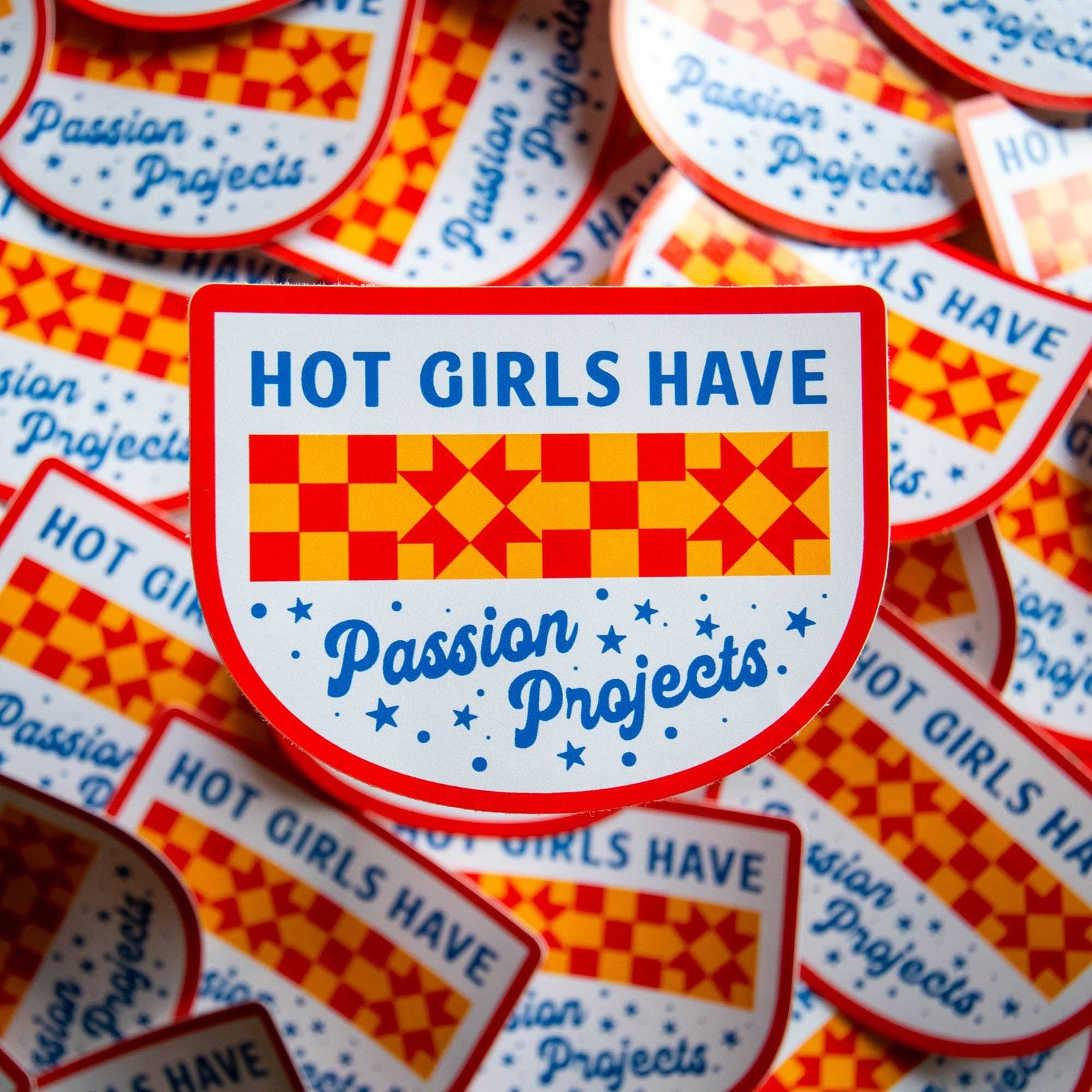 Stack of stickers with 'Hot Girls Have Passion Projects' in blue text on a white background with red border.