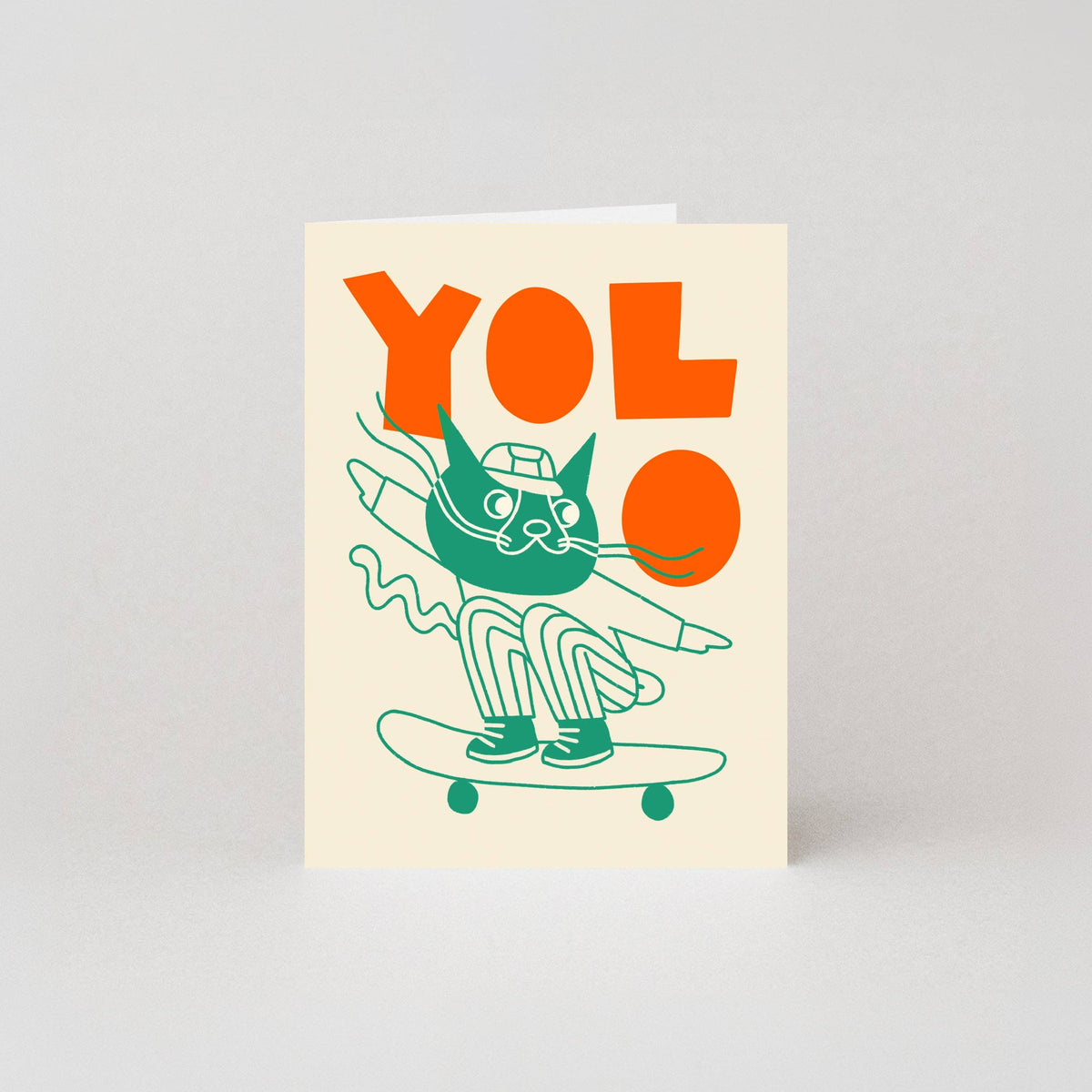 Mini greeting card with a cat on a skateboard and 'Yolo' text on a cream background by studio boketto at penny black