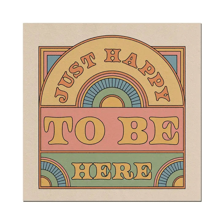 A graphic art print made up on a cream background and pastel rainbow colours on the design. It&#39;s retro in style and says the words in block capitals - Just Happy To Be Here.