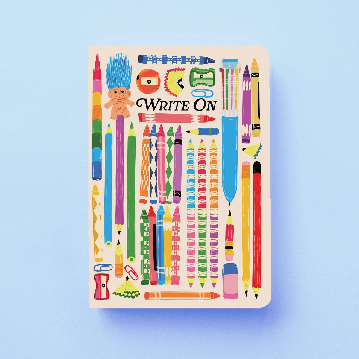 Notebook with colourful stationery illustrations and 'Write On' text on a light blue background