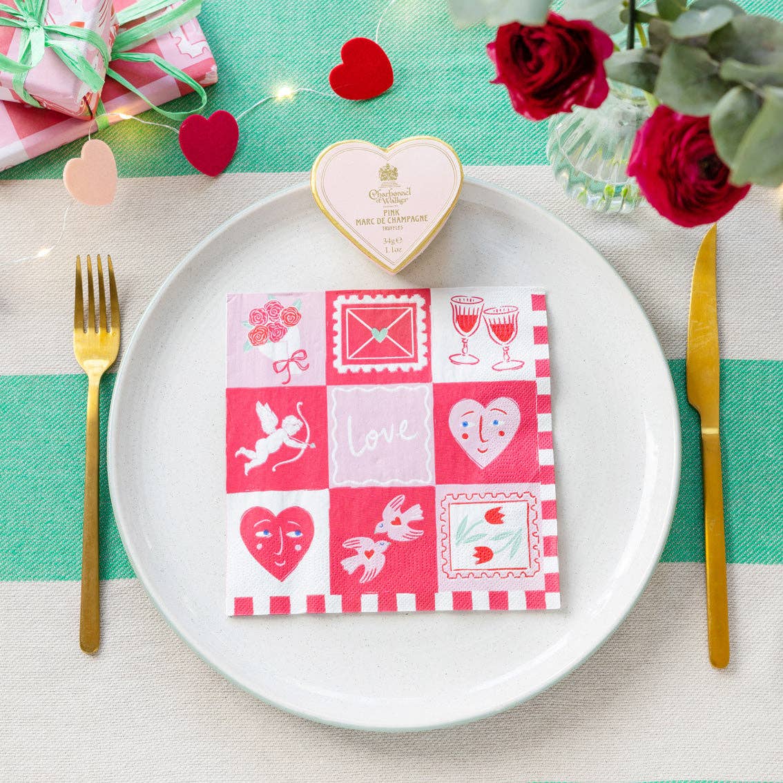 Love Icons Valentine's Day Paper Napkins - 20 Pack shown on a plate and table at penny black