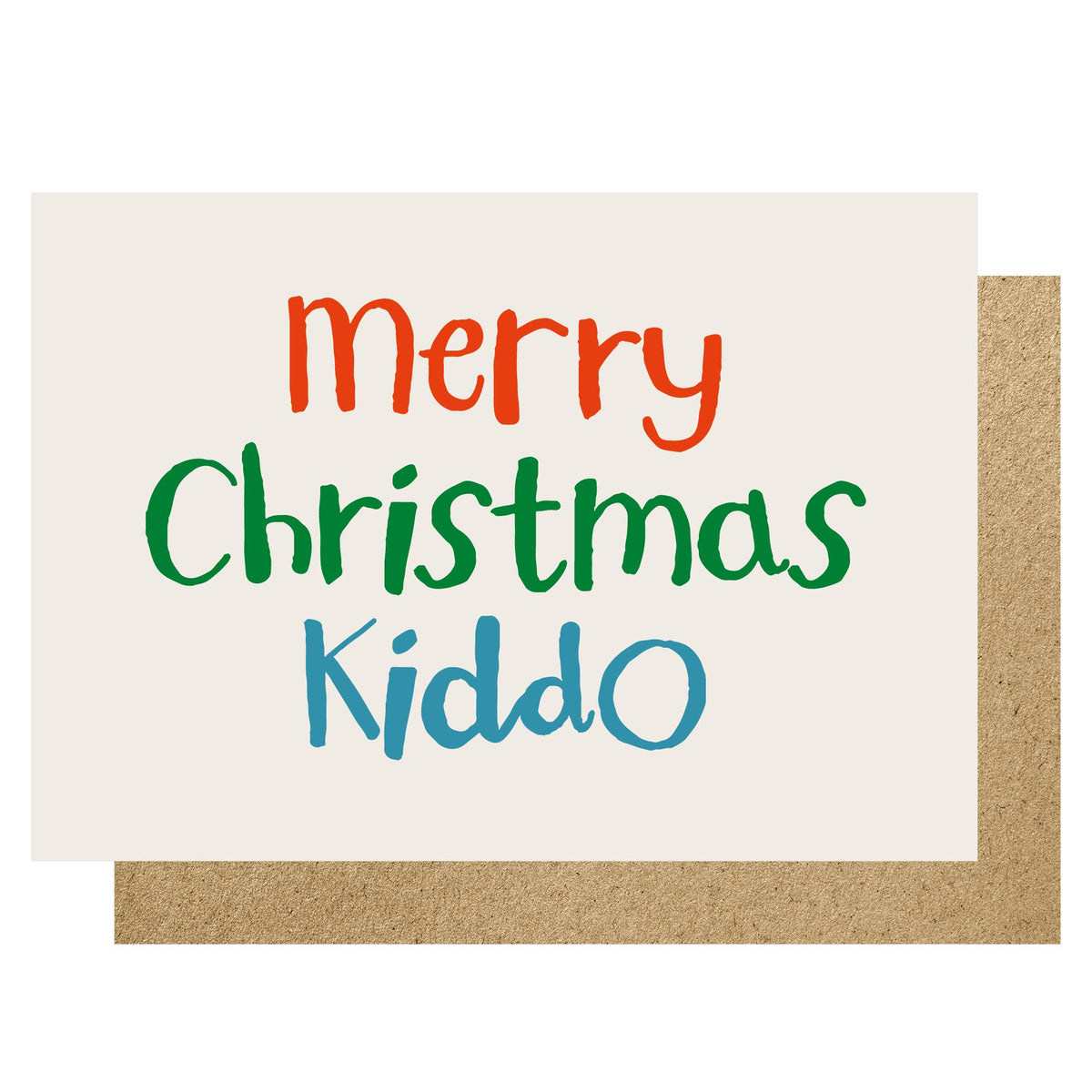 A Christmas greeting card with the text 'Merry Christmas Kiddo' in orange, green, and blue handwritten-style lettering on an off-white card, shown with a brown kraft envelope behind it on a white background.