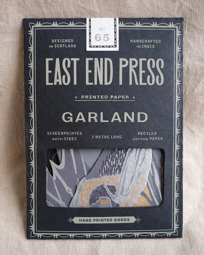 A dark blue package with a cut out window showing a paper garland with a bat design by East End Press.  The bats are monochrome colour and it says it's 3 metres in length.