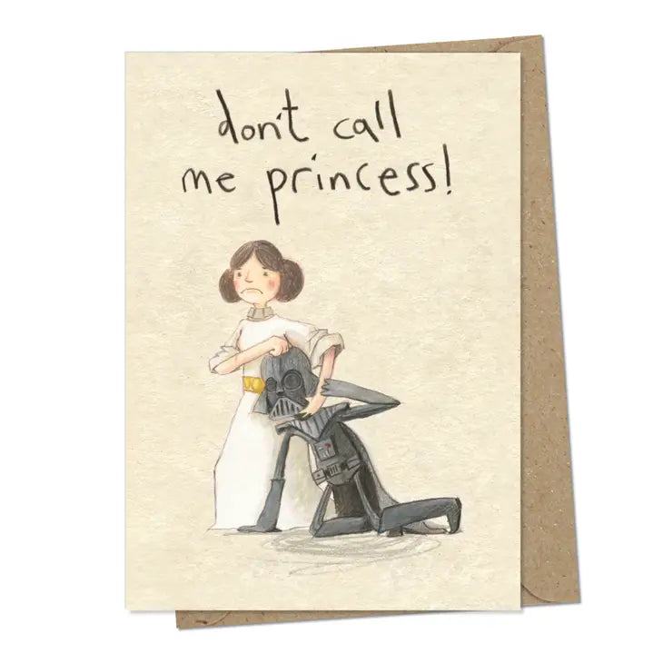 A cream coloured rectangular card with an illustration of Princess Leia with Darth Vader in a headlock. He is on the ground and she's got her hand around his helmet. Above the image are the handwritten words 'Don't call me princess'