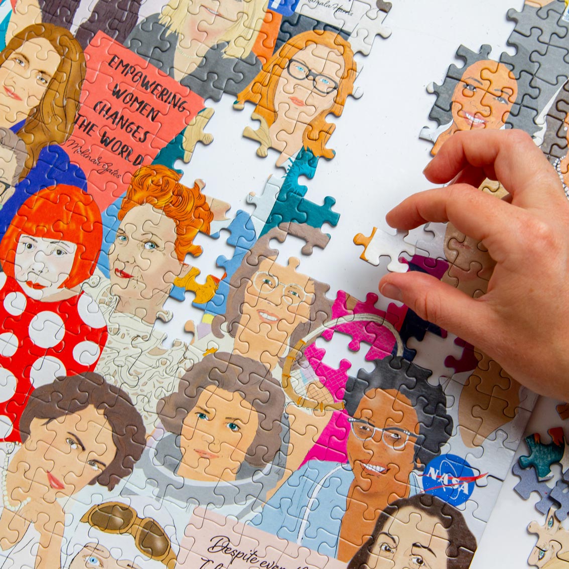 An image of someone with a while complexion completing a jigsaw puzzle featuring Phenomenal Women.