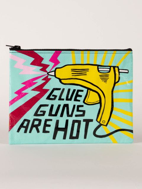 A turquoise zipper pouch with a large yellow glue gun on it with pink zigzags coming from it and the words in bold black capitals &#39;glue guns are hot&#39;