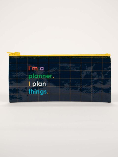 This navy blue pencil case has fine yellow graph paper lines and a yellow zip and in multicolour lettering, I&#39;m a planner, I plan things.