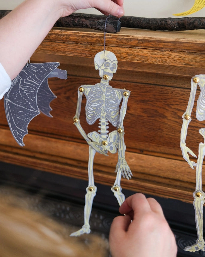 Dancing Skeleton Screen Printed Paper Ornaments on a mantlepiece by east end press at penny black