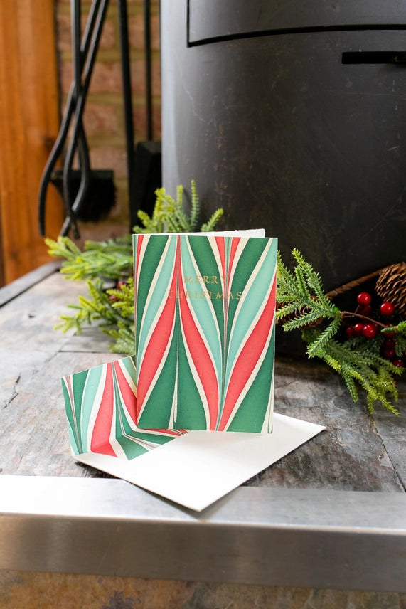 Festive Candy Stripe Hand Marbled Christmas Card with envelope on mantlepiece by penny black