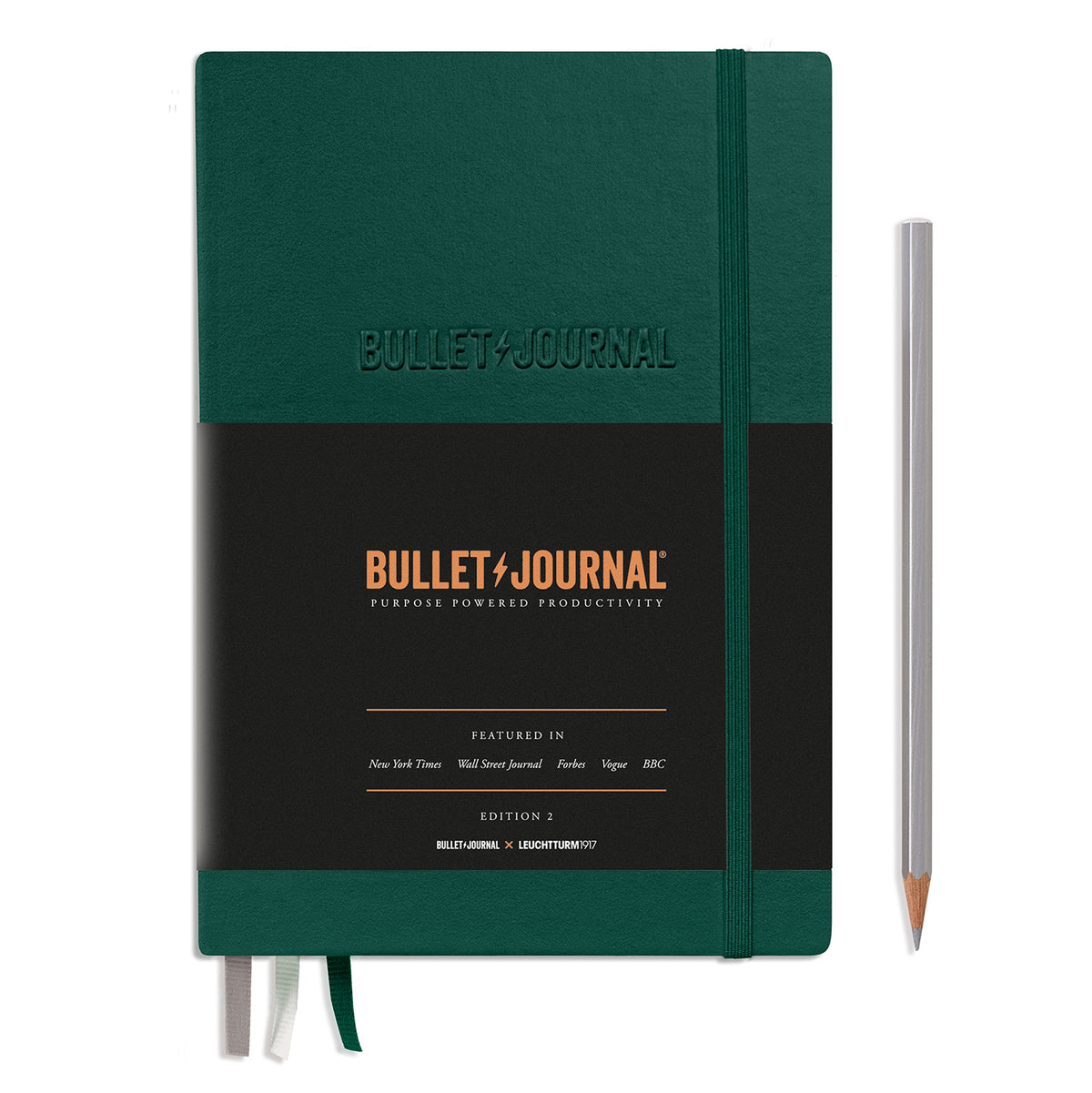 A racing green bullet journal notebook. It has an elastic band keeping it together and a black paper band covering three quarters of the book detailing that it&#39;s a bullet journal. Embossed on the front cover are the words in capitals BULLET JOURNAL.