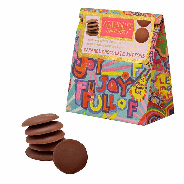 A colourful paper bag featuring the words - full of joy handwritten. Also a sticker describing that the pouch encloses caramel chocolate buttons.
