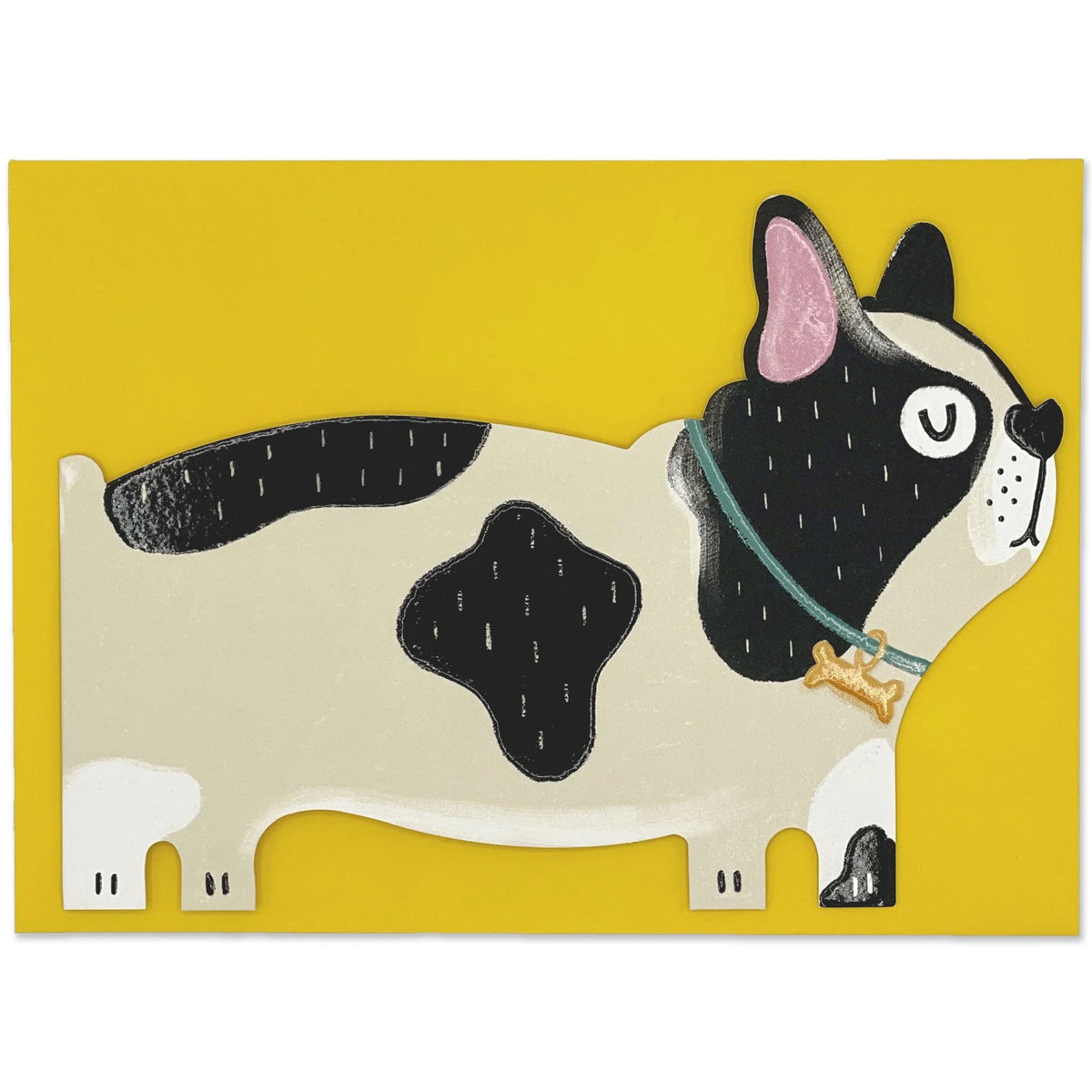 A card cut out in the shape of a black and beige patchy French Bulldog with it&#39;s eyes closed. The dog is standing side facing and has a bone shape attached to it&#39;s green colour. A yellow envelope is behind the dog.
