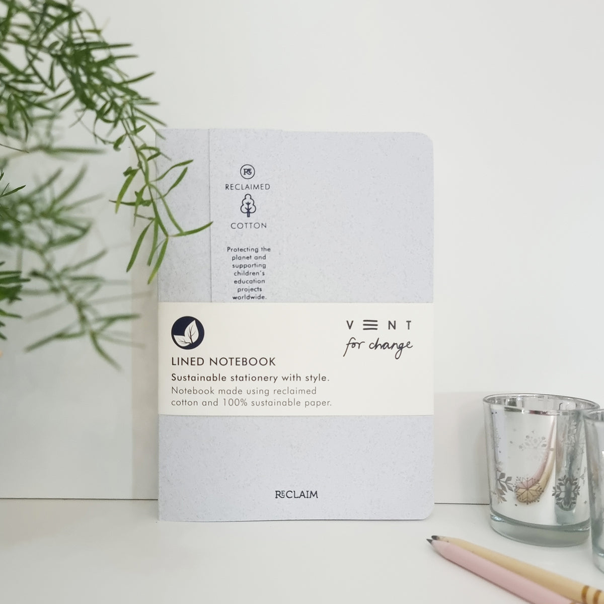 RECLAIM Recycled A5 Lined Notebook in white coloured cotton leaning against a white background by Vent for Change at Penny Black