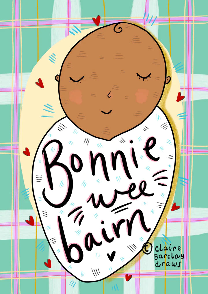 A greetings card with green and pink tartan background and an Asian or mixed heritage baby swaddled in a white blanket, with wording Bonnie Wee Bairn across it.